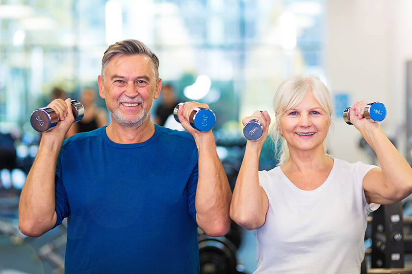 Senior couple exercising in gym 